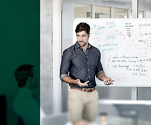 An instructor standing in front of a white board