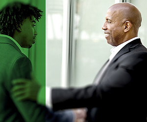 An experienced professional speaking with a young man